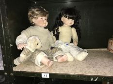 2 porcelain head collectors dolls and a teddy bear.