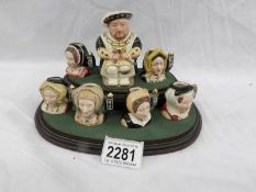 A Royal Doulton limited edition character jug set on stand being Henry VIII and his six wives.