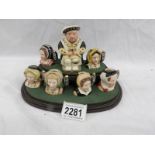 A Royal Doulton limited edition character jug set on stand being Henry VIII and his six wives.