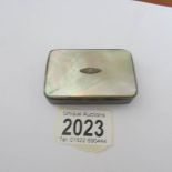 An unmarked white metal and mother of pearl snuff box.