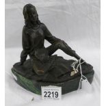 A bronze figure of a lady with book.