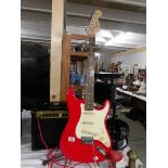 A Red Squire Strat guitar with 10w Park amp and lead.