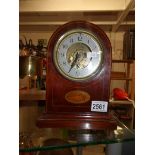 A mahogany inlaid mantel clock.