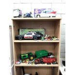 A quantity of Die cast cars (3 shelves), Ghostbusters, Petrol Car, and farming vehicles.