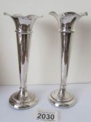 A pair of silver spill vases.