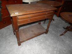 An oak 2 drawer table.