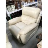 A cream reclining arm chair,