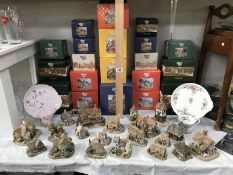 A quantity of boxed Lilliput Lane cottages and 2 sandwich plates with cups.