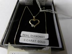 A 9ct gold heart pendant set diamond.