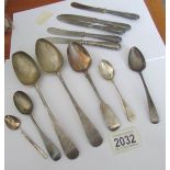 7 silver spoons and 5 silver handled knives.