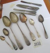 7 silver spoons and 5 silver handled knives.