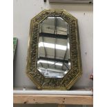 A decorative gilded mirror.