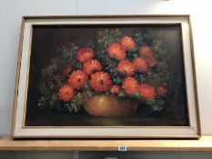 A large oil on canvas of flowers.