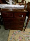 A small 2 over 3 mahogany inlaid chest of drawers,.