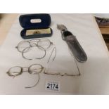 A Victorian spectacle case with belt hook, 3 pairs of vintage spectacles and a pair of pince nez.