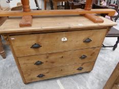 A pine chest of drawers.