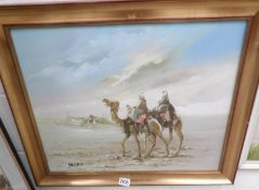 A framed oil on canvas depicting camels in a desert signed Jing H Jee.