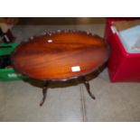 A small oval mahogany coffee table.