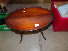 A small oval mahogany coffee table.