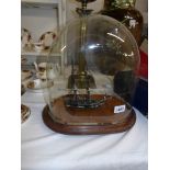 A 19th century model of a galleon under glass dome.