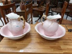 A pair of pink jug and basin sets, a/f.