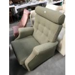 A green fabric arm chair.