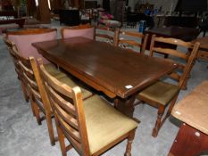 An oak dining table with 6 chairs.