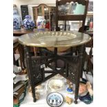 A brass topped table with decorative legs.