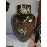 A large floral decorated pottery vase.