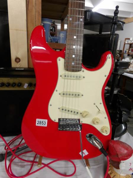 A Red Squire Strat guitar with 10w Park amp and lead. - Image 2 of 4