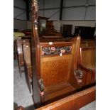 A carved oak lectern with seat in front.