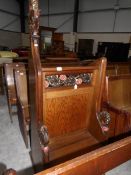 A carved oak lectern with seat in front.