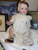 A Victorian porcelain doll marked Melitta, Germany.