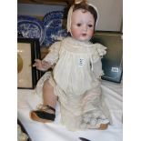 A Victorian porcelain doll marked Melitta, Germany.