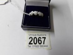 An 18ct white gold ring being 5 hearts set with diamonds of 40 pts, size M.