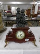 A French marble clock surmounted 2 children, (cracks to marble).