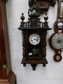 A small mahogany wall clock.