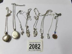 8 assorted silver lockets and pendants all on silver chains.
