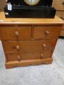 A small pine chest of drawers.