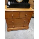 A small pine chest of drawers.