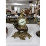 A brass clock supported by an elephant.