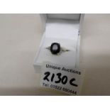 An 18ct gold ring set jet stone and 2 diamonds, size O, gross weight 4 grams.