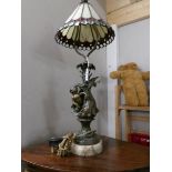A cherub table lamp with Tiffany style shade.