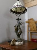 A cherub table lamp with Tiffany style shade.