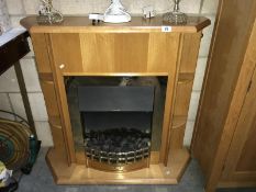 A coal effect electric fire in pine effect surround.