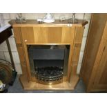 A coal effect electric fire in pine effect surround.