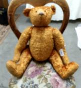 A vintage jointed Teddy bear.