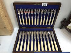 A 1930's oak cased canteen of fish cutlery.