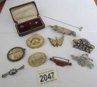 A mixed lot of vintage brooches including carved examples.