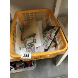 A plastic basket of GB and world stamps.